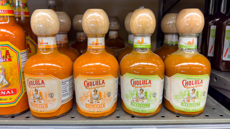 Bottles of Cholula sauce on a store shelf