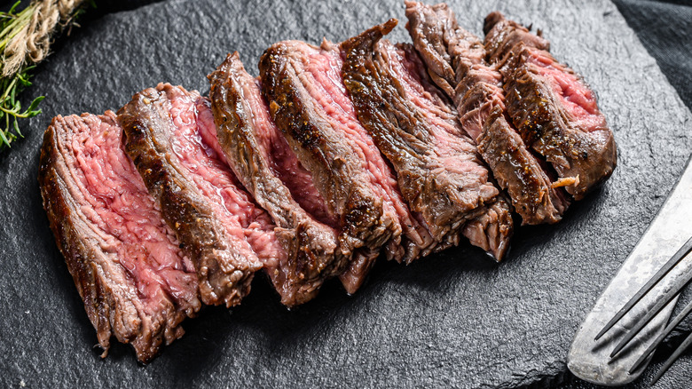 Sliced steak on board