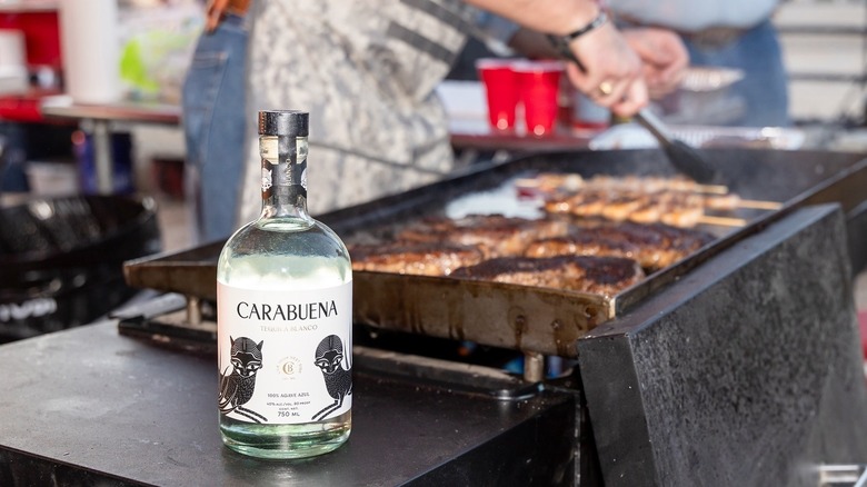 A bottle of Carabuena next to a grill