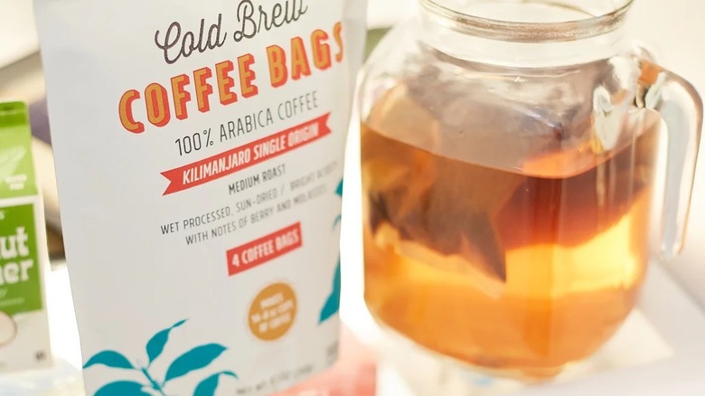 package of Trader Joe's cold brew coffee bags inside of fridge next to pitcher of steeping cold brew