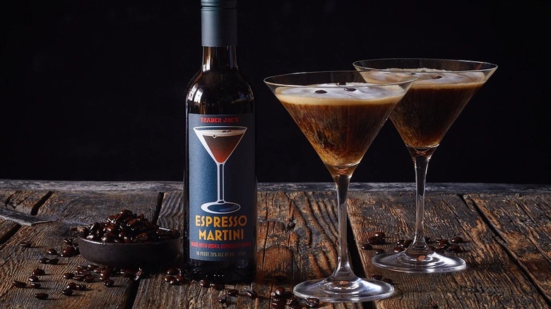 bottle of Trader Joe's espresso martini on table next to two espresso martinis