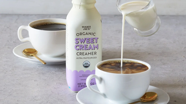 pouring Trader Joe's Sweet Cream Creamer into cup of coffee next to carton