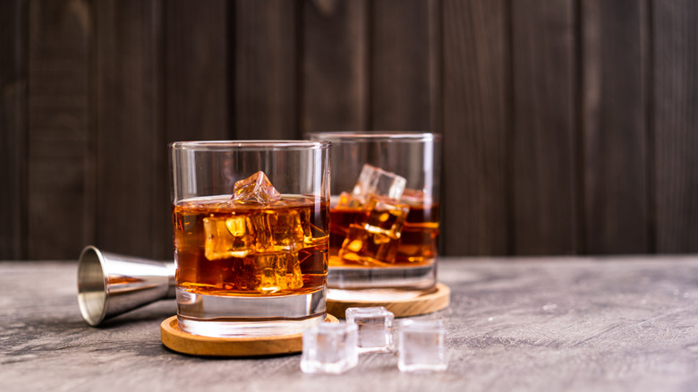 Two glasses of bourbon and ice