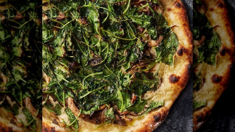 Vegan pizza with cooked spinach
