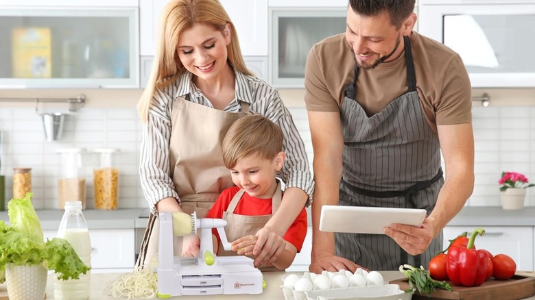 A family spiralizing vegetables with a Breiftson vegetabl spiralizer