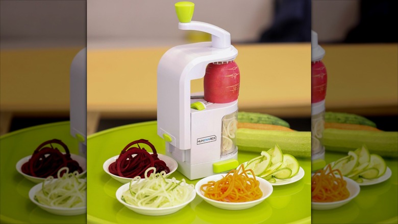 A Nunewares veggie spuiralizer cutting a radish