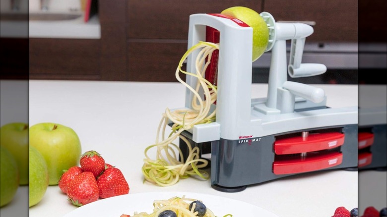 A Westmark veggie spiralizer slicing an apple