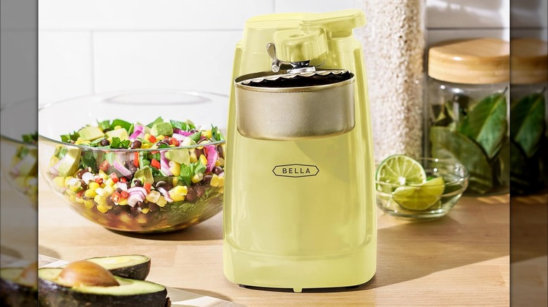 Bella Electric Can Opener and Knife Sharpener on a counter with open can attached