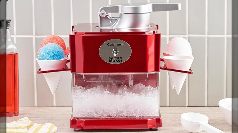 Cuisinart Snow Cone Machine on a counter with red and blue cones