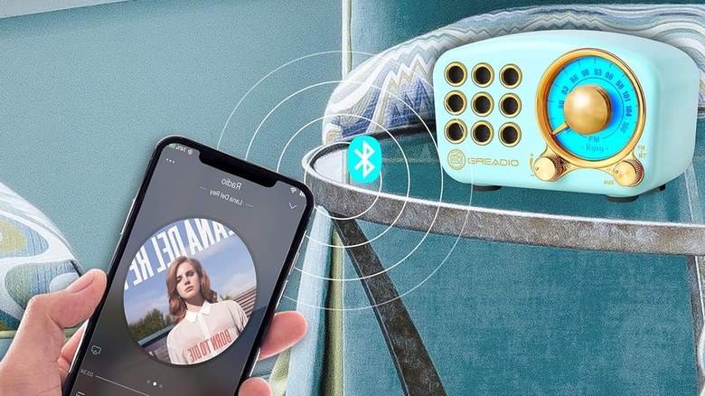 Greadio retro bluetooth speaker on a table with a smartphone in the foreground