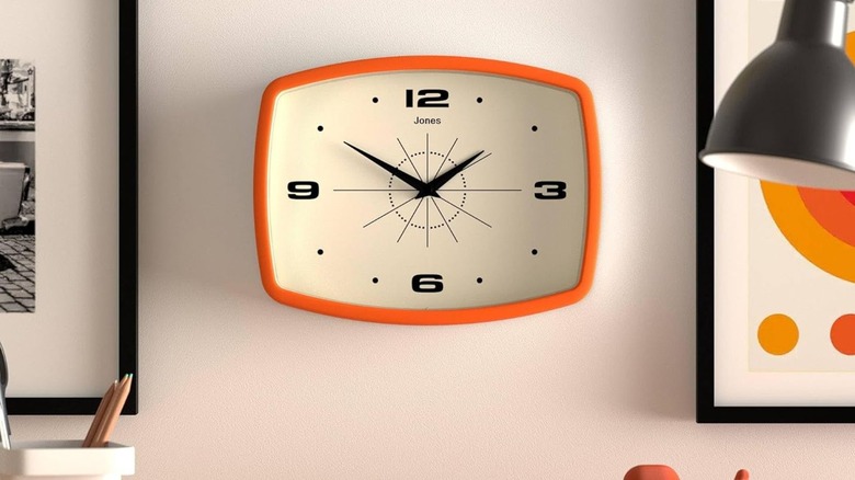 Jones Clocks Retro Rectangular Clock in orange on a wall