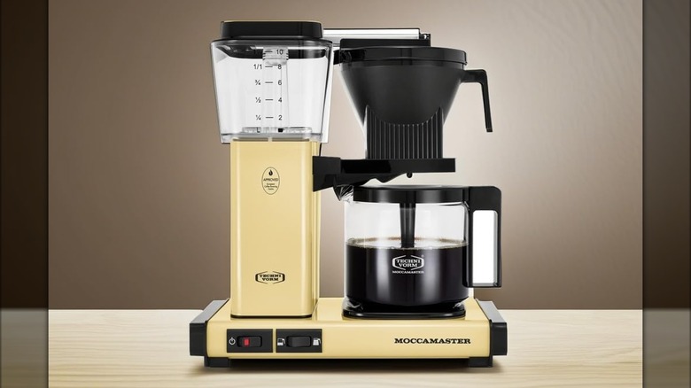 Technivorm Moccamaster coffee maker in yellow on a table