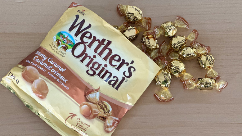 Bag of Werther's Original Creamy Caramel Filled Hard Candies next to wrapped candies