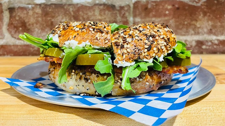Bagel sandwich with lettuce on a tray