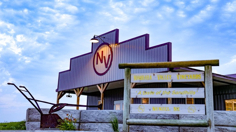 Front view of Niobrara Valley Winery's cattle ranch-style tasting room under blue skies.