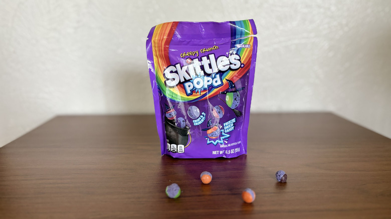 Skittles Pop-d Creepy Crunch on table with skittles