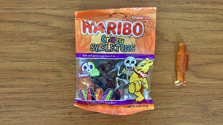 Haribo Crazy Skeletons bag next to one of its crazy skeleton gummies