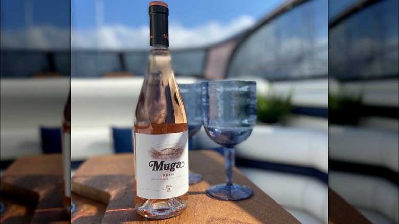 Bottle and glass of Muga rosé wine outdoors