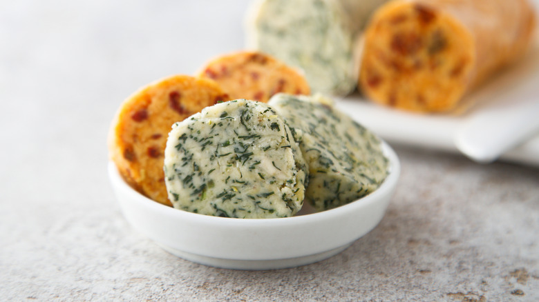 Slices of compound butter in small white dish
