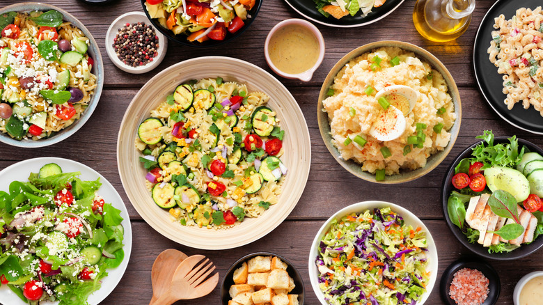 Assortment of salad bowls and toppings on table