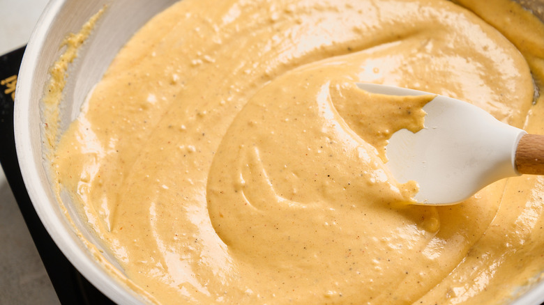 stirring cheese into the skillet