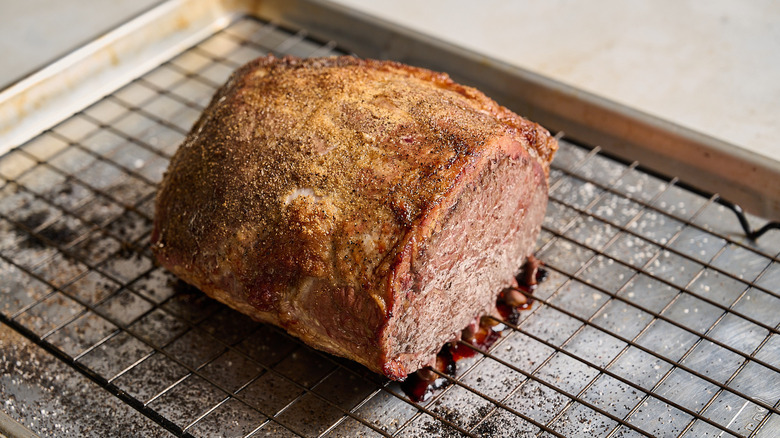 roast beef cooling on a wire rack