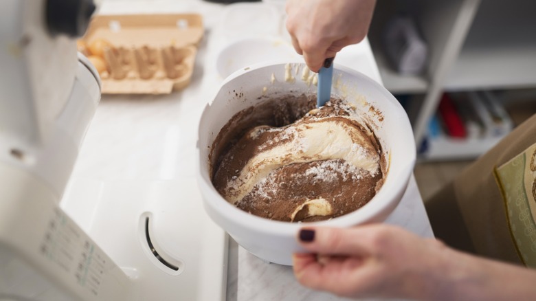 Person mixing cake batter by hand.