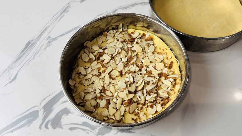 Almonds over dough in cake pan