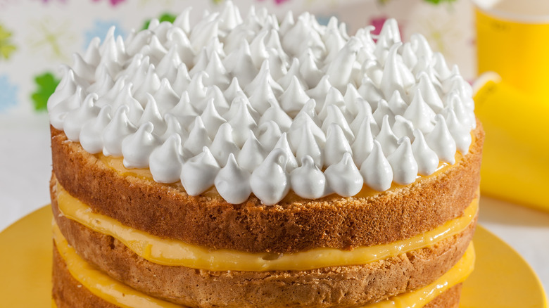 layered coconut cake with meringue topping