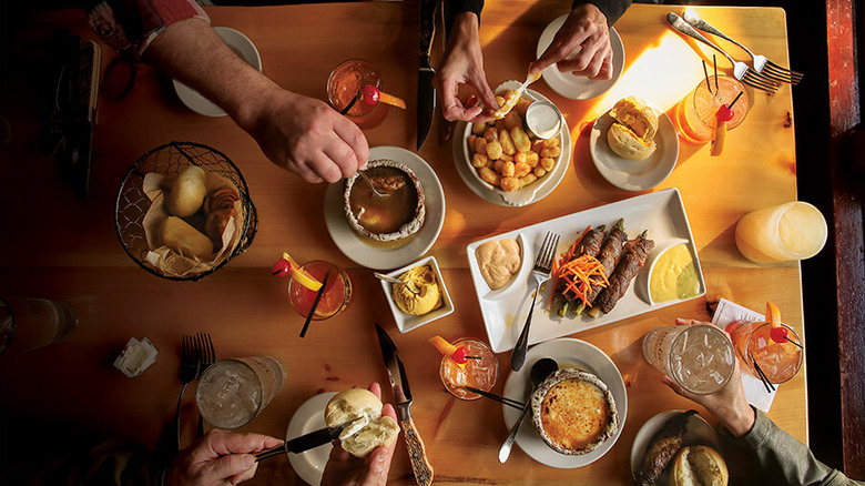 Above view of the supper table with various foods and drinks.