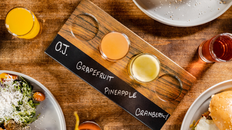 Breakfast with mimosa flight featuring various fruit juice types