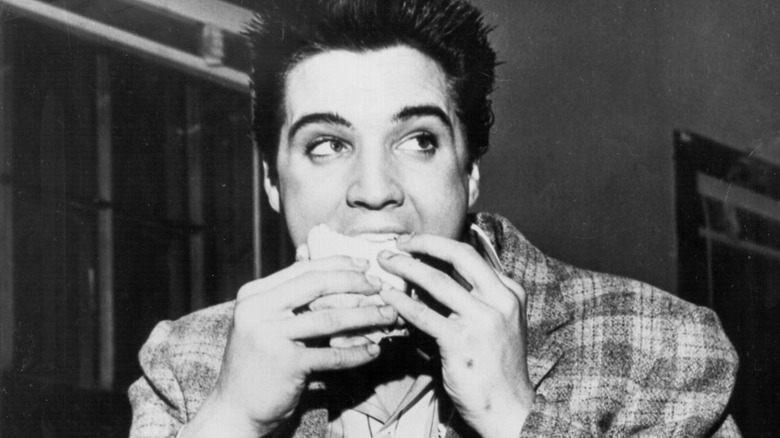 Elvis Presley eating a sandwich