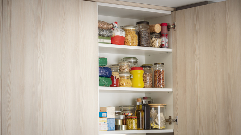 overstuffed cabinets filled with jars and bags that are hard to reach