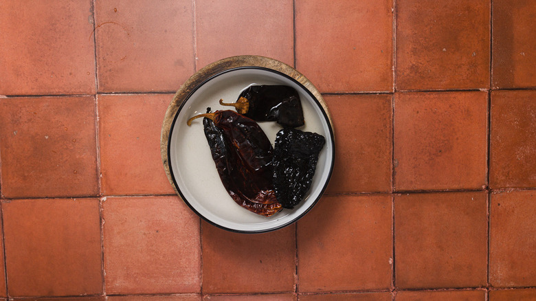 Chiles soaking in water in a bowl