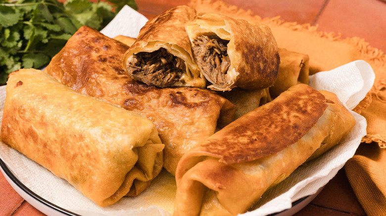 Fried chimichangas on plate