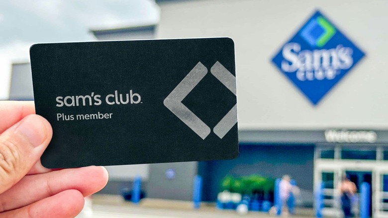 Hand holding Sam's Club Plus member card