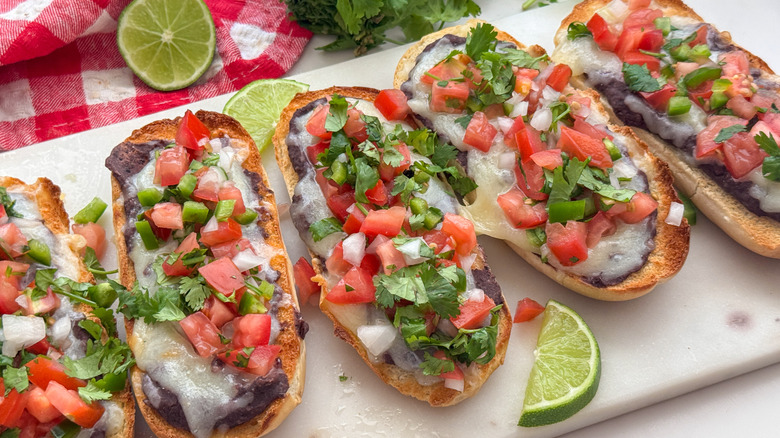 Pico de gallo-topped molletes on platter