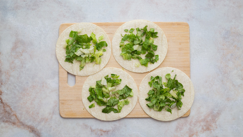 shredded lettuce on 4 tortillas