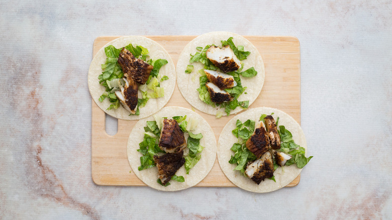 fish tacos on wooden board