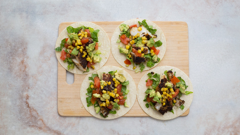 fish tacos on wooden board