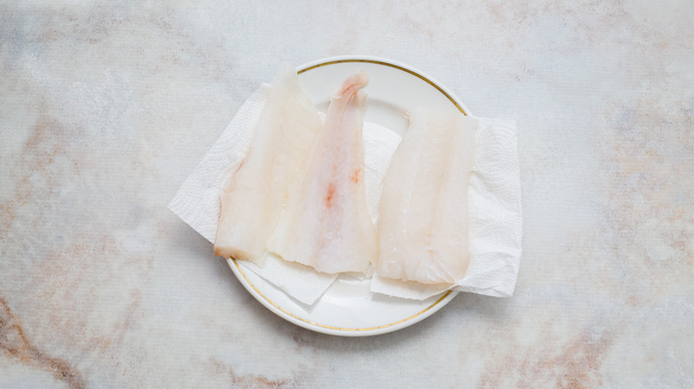 raw cod on marble table