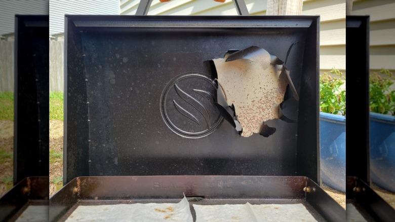 The inside of a Blackstone grill with paint feeling off excessively