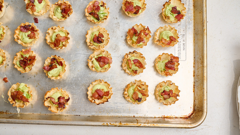 bacon bits sprinkled onto phyllo cups