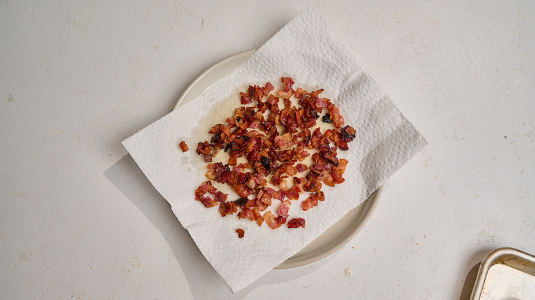 draining bacon on paper-towel lined plates