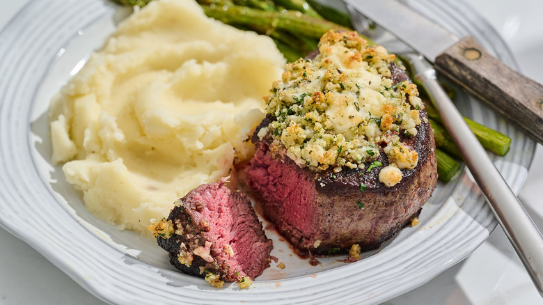 Filet mignon on a plate with a slice cut off