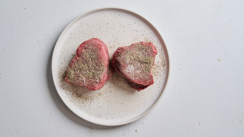seasoned steaks on a plate