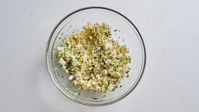 cheese and parsley added to bowl with panko
