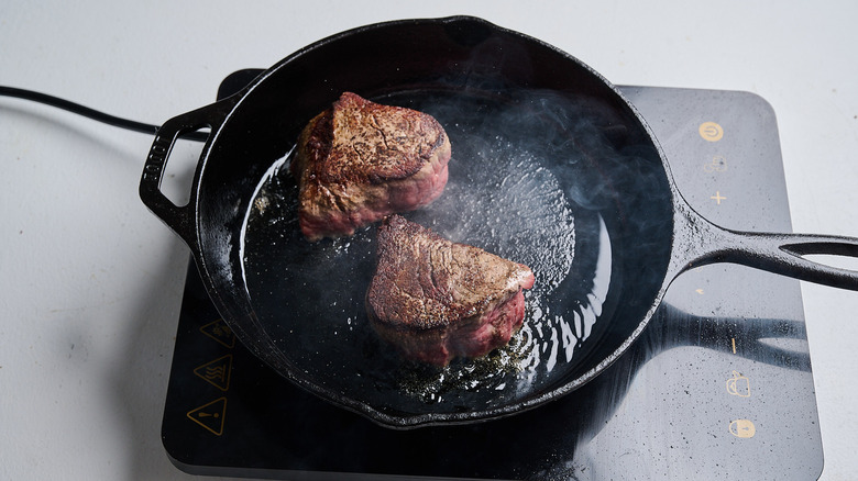 searing steaks in a skillet