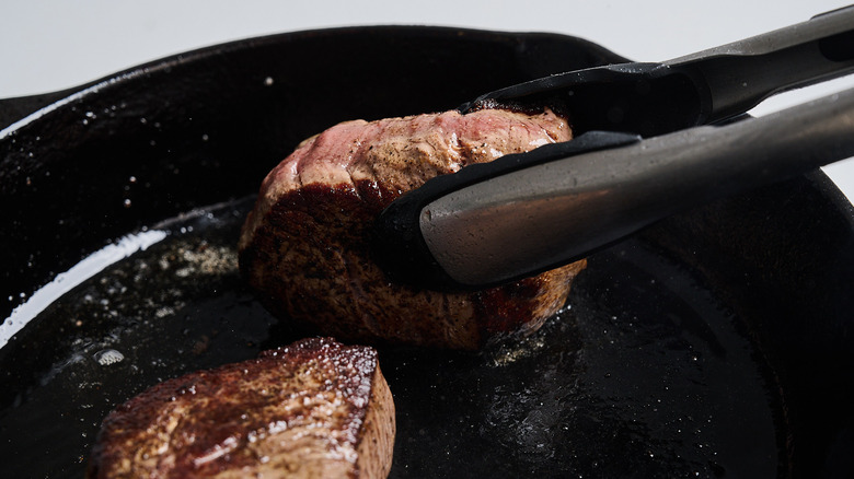Browning the sides of the steaks in the skillet
