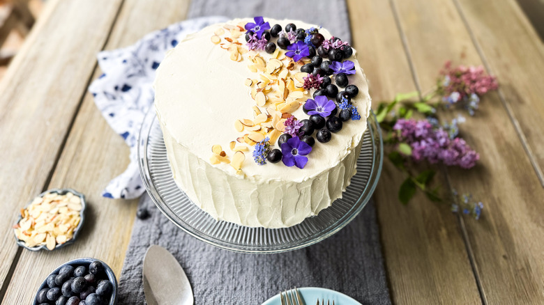 Blueberry and almond Chantilly cake with fresh flower and blueberry garnish